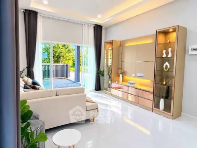 Modern living room with elegant decor and large sliding glass doors opening to a balcony.