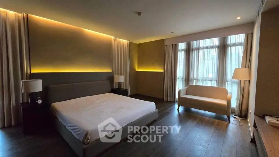 Luxurious bedroom with modern lighting and large windows in upscale apartment