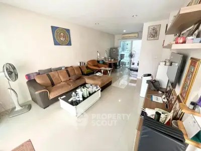 Spacious living room with modern decor and natural light, perfect for relaxation and entertainment.