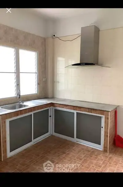 Spacious kitchen with modern hood and ample counter space