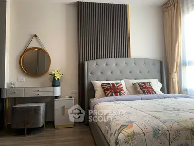 Stylish bedroom with modern decor and natural light, featuring a plush bed and elegant vanity.