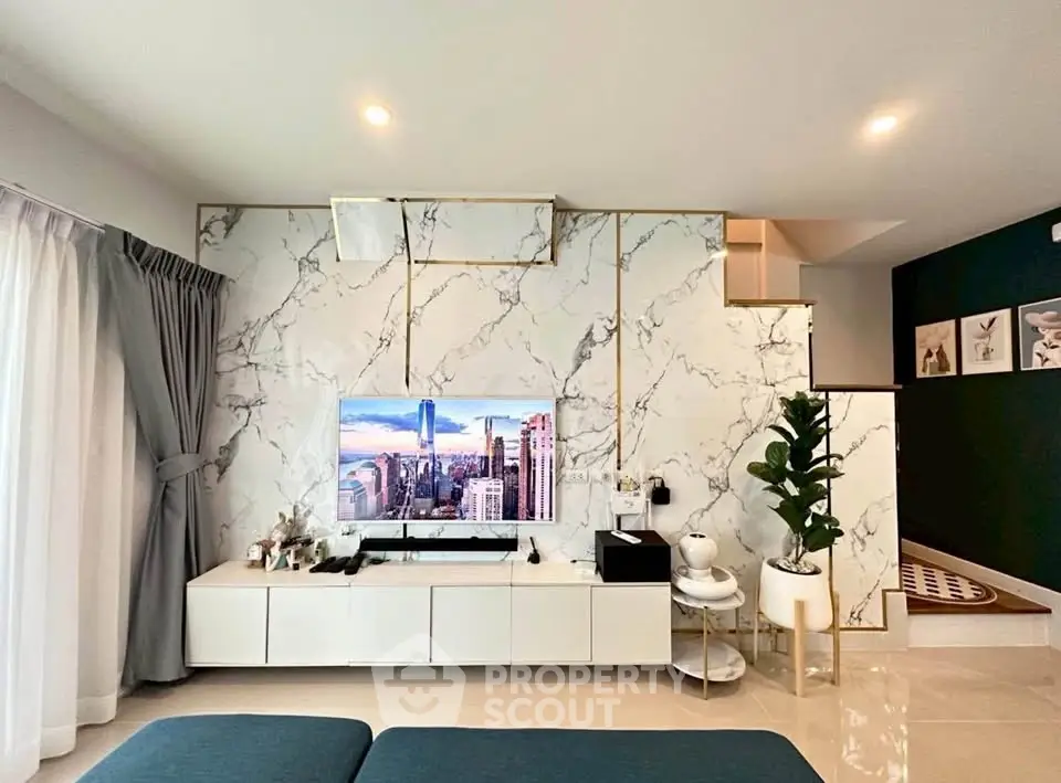 Luxurious modern living room with marble accent wall and sleek entertainment center.