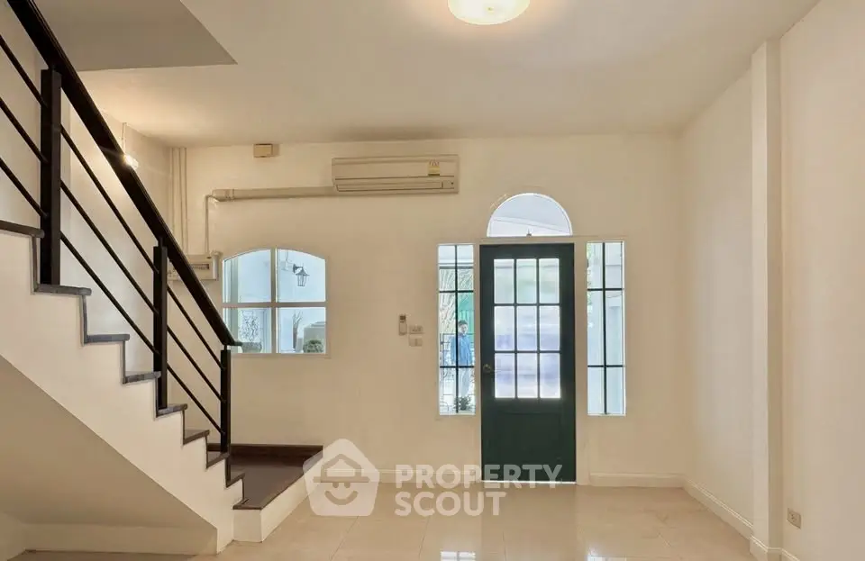 Spacious interior with modern staircase and natural light