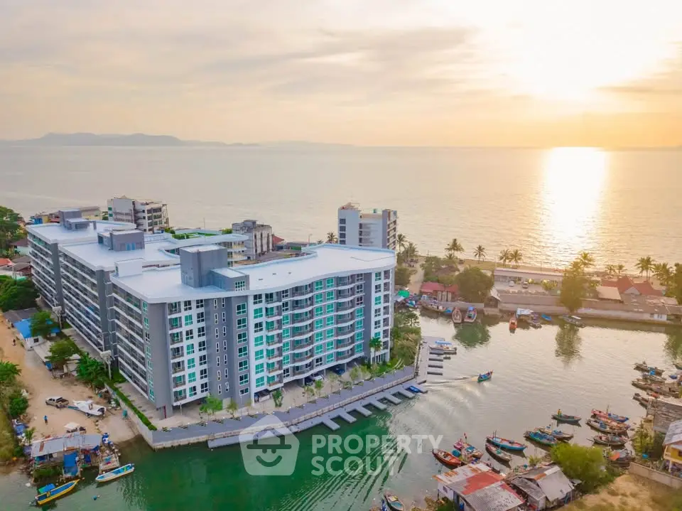 Stunning waterfront apartment building with breathtaking ocean views at sunset.