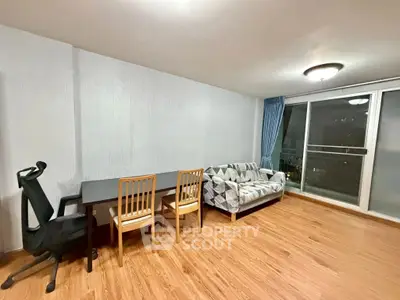 Spacious living room with modern furniture and large windows for natural light.