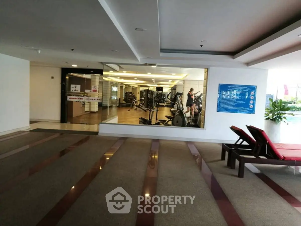 Spacious gym with modern equipment in a luxury residential building.