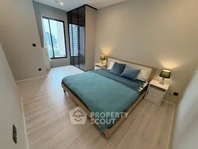 Modern bedroom with city view, featuring sleek design and cozy ambiance.