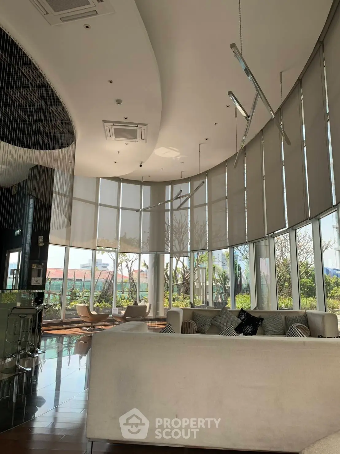 Luxurious modern living room with floor-to-ceiling windows and elegant decor