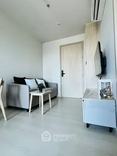 Modern living room with sleek furniture and minimalist decor in a bright apartment.