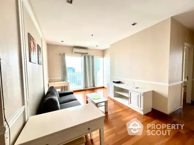 Bright living room with wooden flooring and modern furniture in a high-rise apartment