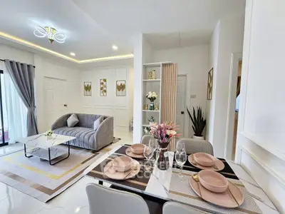 Elegant modern living room with stylish decor and dining area, perfect for entertaining guests.
