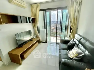 Modern living room with city view, sleek furniture, and large windows for natural light.
