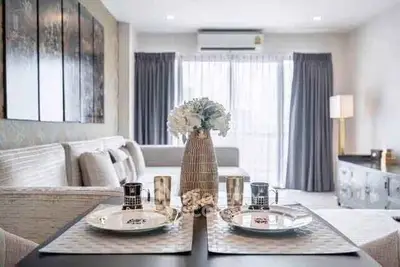 Elegant modern living room with stylish dining setup and natural light