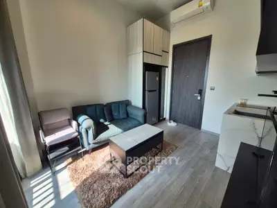 Modern living room with sleek furniture and natural light in a stylish apartment.