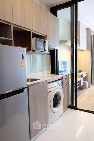 Modern kitchen with sleek appliances and open layout in a stylish apartment.