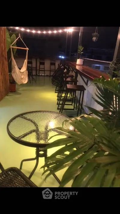 Charming balcony with cozy seating and ambient lighting, perfect for relaxing evenings.
