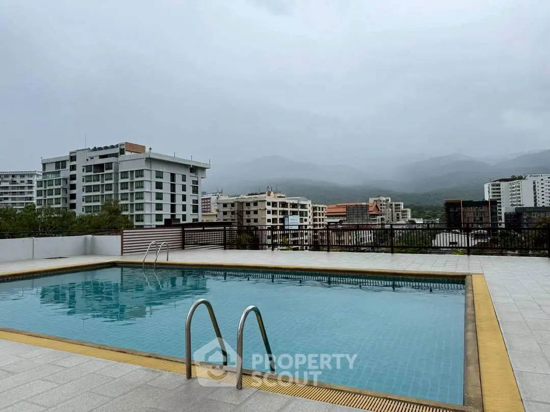 Stunning rooftop pool with panoramic city and mountain views, perfect for relaxation and leisure.