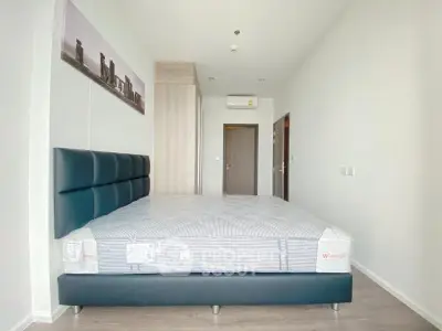 Modern bedroom with stylish bed and minimalist decor in a bright apartment.