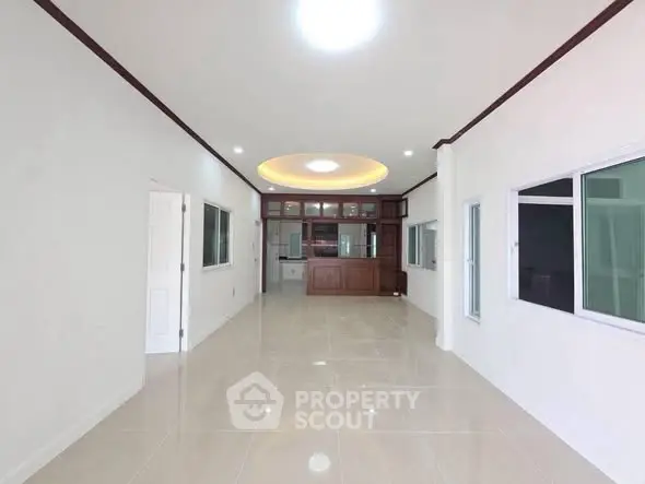 Spacious open-plan living room with modern design and ample natural light.