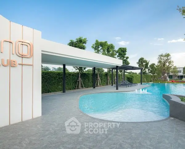 Luxurious outdoor pool area with modern design and lush greenery, perfect for relaxation and leisure.