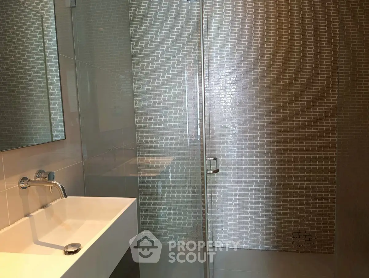 Modern bathroom with sleek glass shower and stylish tile design
