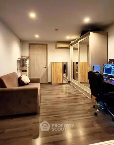 Modern study room with sleek wooden flooring and stylish furniture, perfect for productivity and comfort.