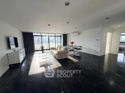 Spacious modern living room with city view and sleek black flooring