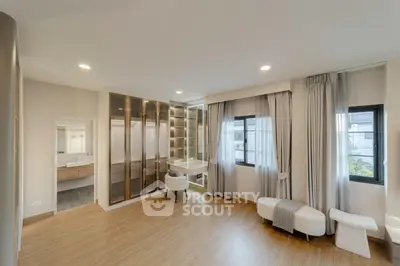 Spacious modern bedroom with elegant decor and ample natural light