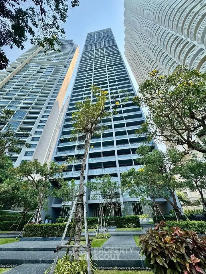 Stunning high-rise building with lush landscaped gardens and modern architecture.