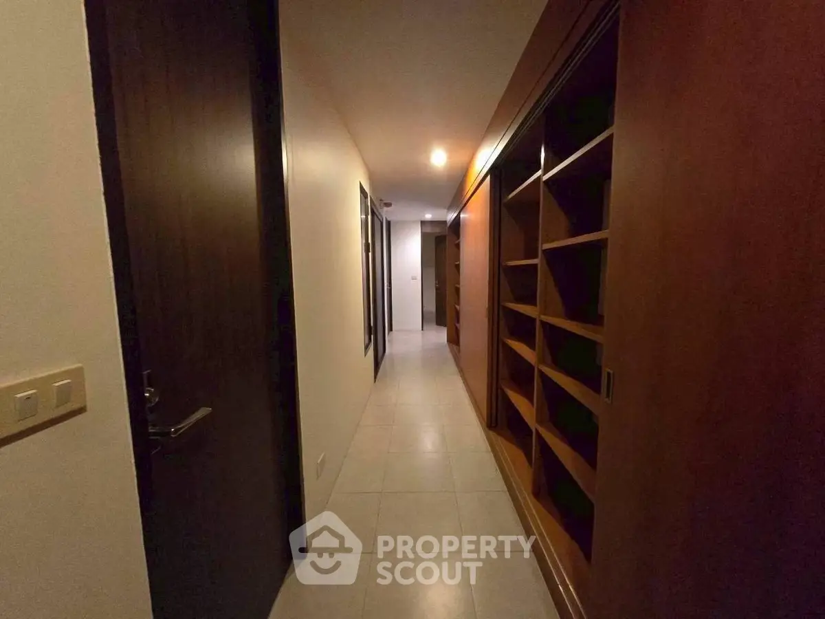 Spacious hallway with elegant wooden shelving and modern lighting