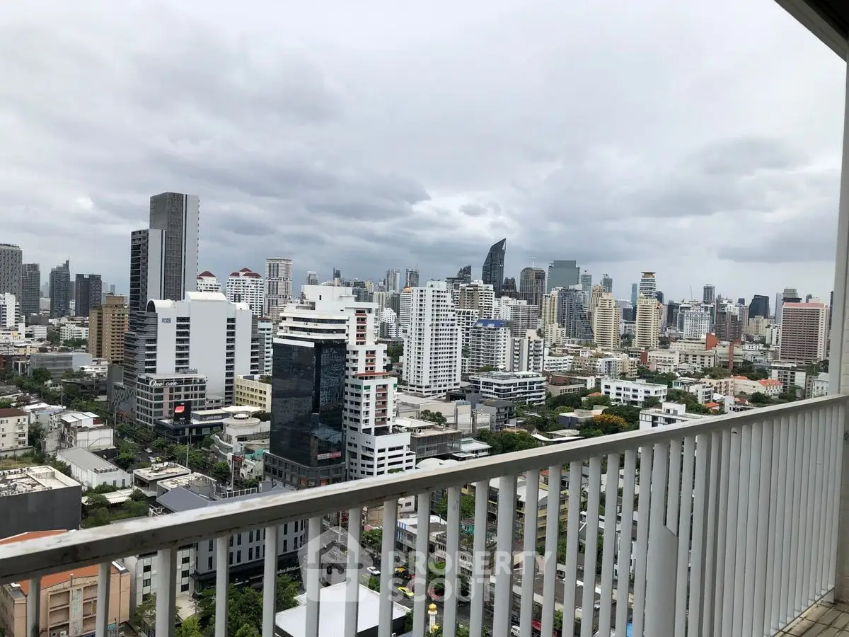 Stunning cityscape view from a high-rise balcony, showcasing urban skyline and modern architecture.