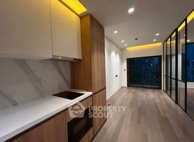 Modern kitchen with sleek cabinetry and open layout in high-rise apartment