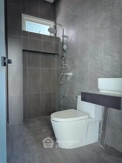 Modern bathroom with sleek gray tiles and contemporary fixtures