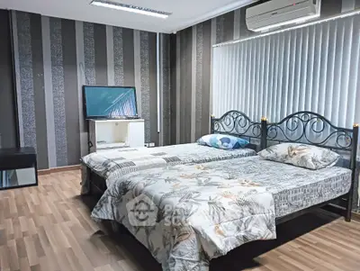 Spacious bedroom with twin beds and modern decor
