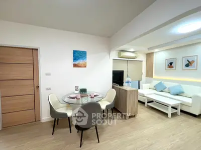 Modern living room with stylish decor and dining area, featuring a cozy ambiance.