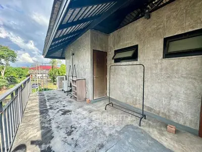 Spacious balcony with modern concrete finish and scenic views.