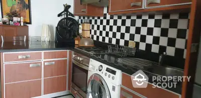 Modern kitchen with checkered backsplash and integrated washing machine