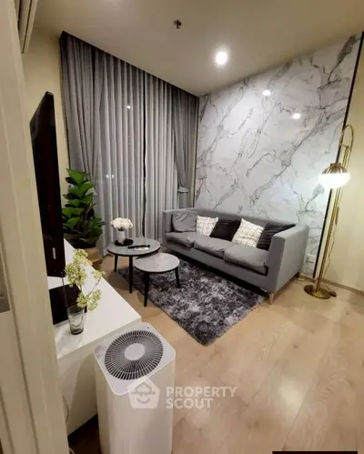 Stylish modern living room with marble accent wall and cozy gray sofa