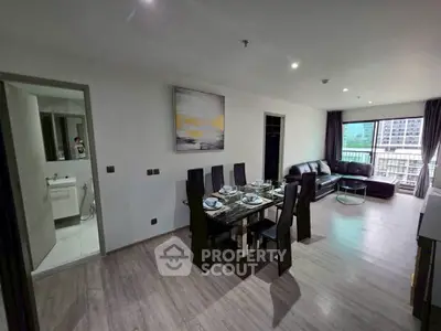 Spacious modern living room with dining area and city view balcony