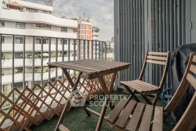 Charming balcony with wooden furniture and city view, perfect for relaxation.