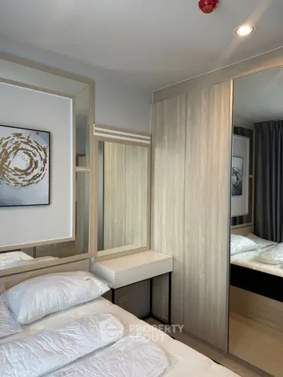 Modern bedroom with stylish decor and ample storage space