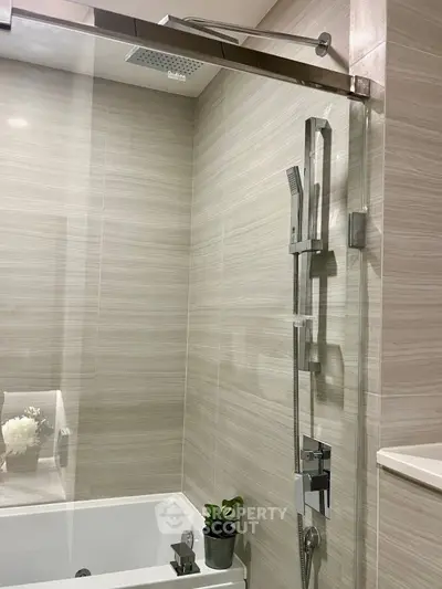 Modern bathroom with sleek shower fixtures and elegant tiling