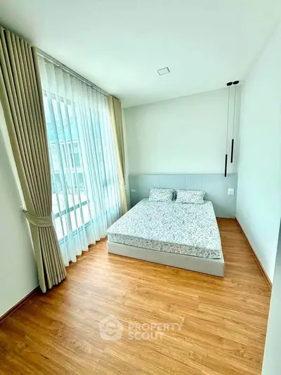 Bright and airy bedroom with large window and modern decor