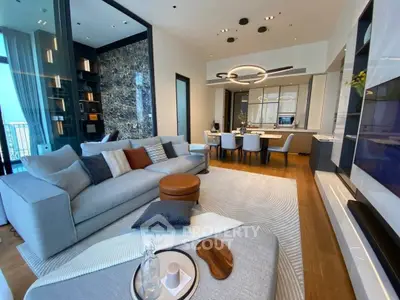 Luxurious modern living room with elegant decor and open layout, featuring a spacious seating area and stylish dining space.