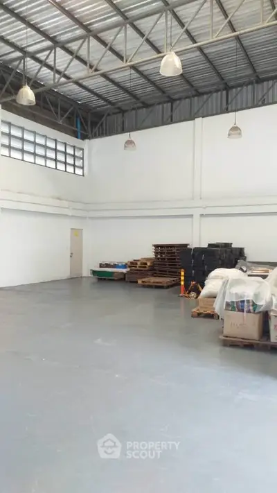 Spacious industrial warehouse with high ceilings and ample storage space.