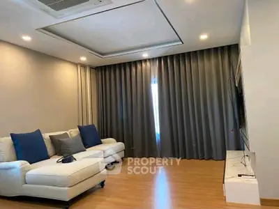 Modern living room with cozy white sofa and elegant curtains