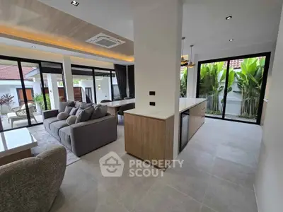 Luxurious open-plan living room with modern kitchen and garden view