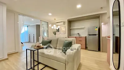 Modern living room with cozy sofa and open kitchen layout