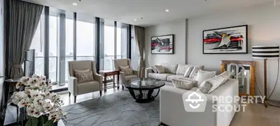 Luxurious modern living room with panoramic city views and elegant decor.