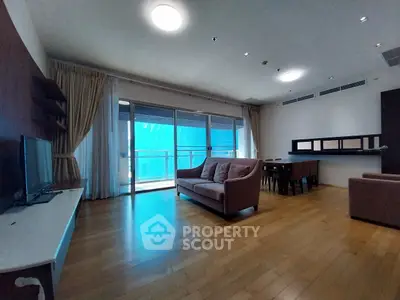 Spacious living room with modern furniture and large windows for natural light.